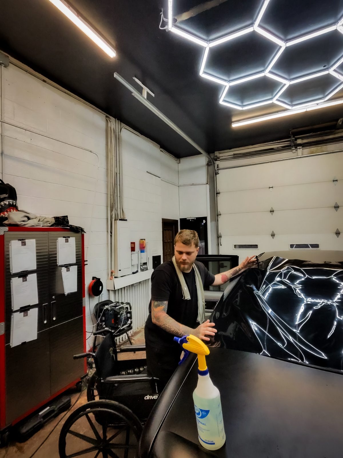 Echelon Auto Studio's founder at work under the studio's hex lighting