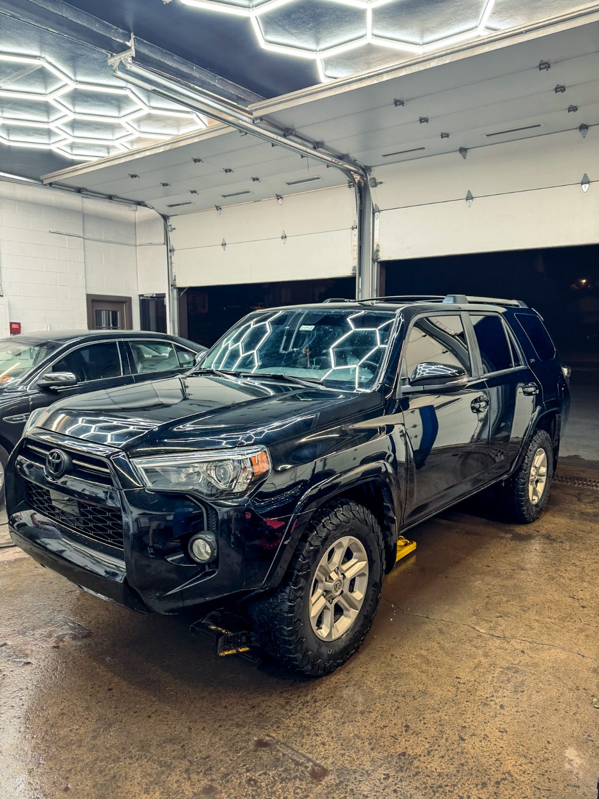 Black Toyota 4Runner detailed under hex lighting